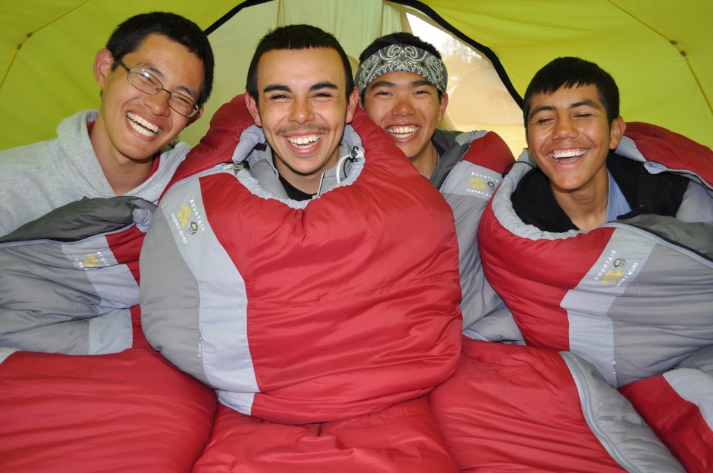TracyBaynes-ak-seakayaking Four teens smile while in sleeping bags
