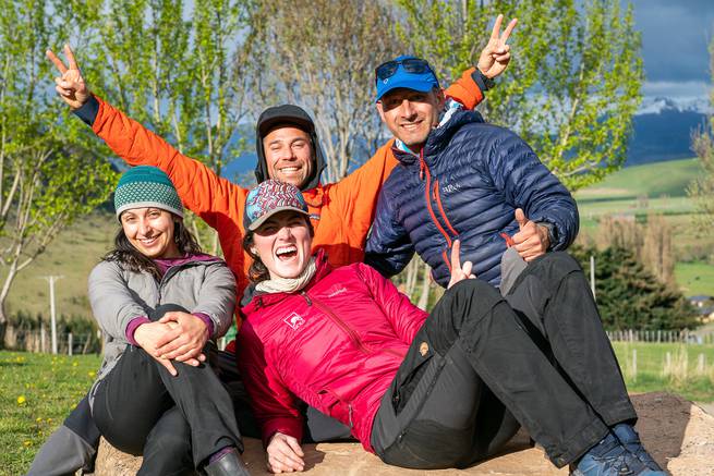 Four course participants smile and pose for a photo together in patagonia.