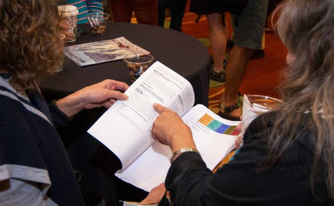 Two conference attendees look at the conference schedule.