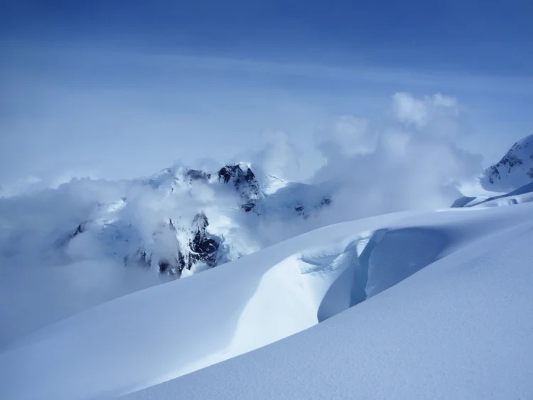 Snowy peaks with a blue sky in the background