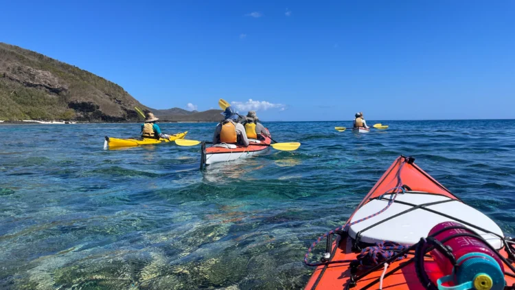 Kayakers paddle in the ocean in Fiji